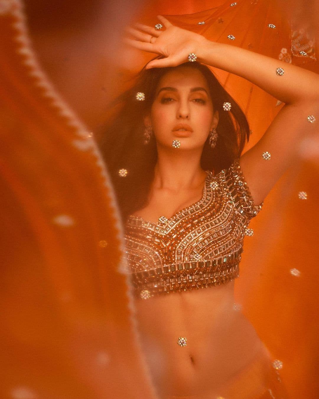 Nora Fatehi looks like a dream in orange lehenga set