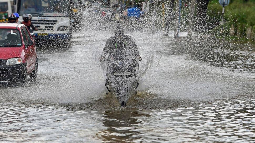 Motorist wading through a waterlogged road