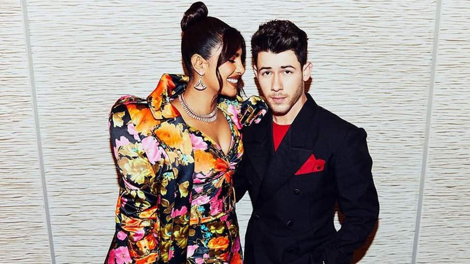 Nick Jonas fixes Priyanka Chopra&#039;s trailing floral coat at red carpet, fans shout &#039;such a gentleman!&#039; - Watch