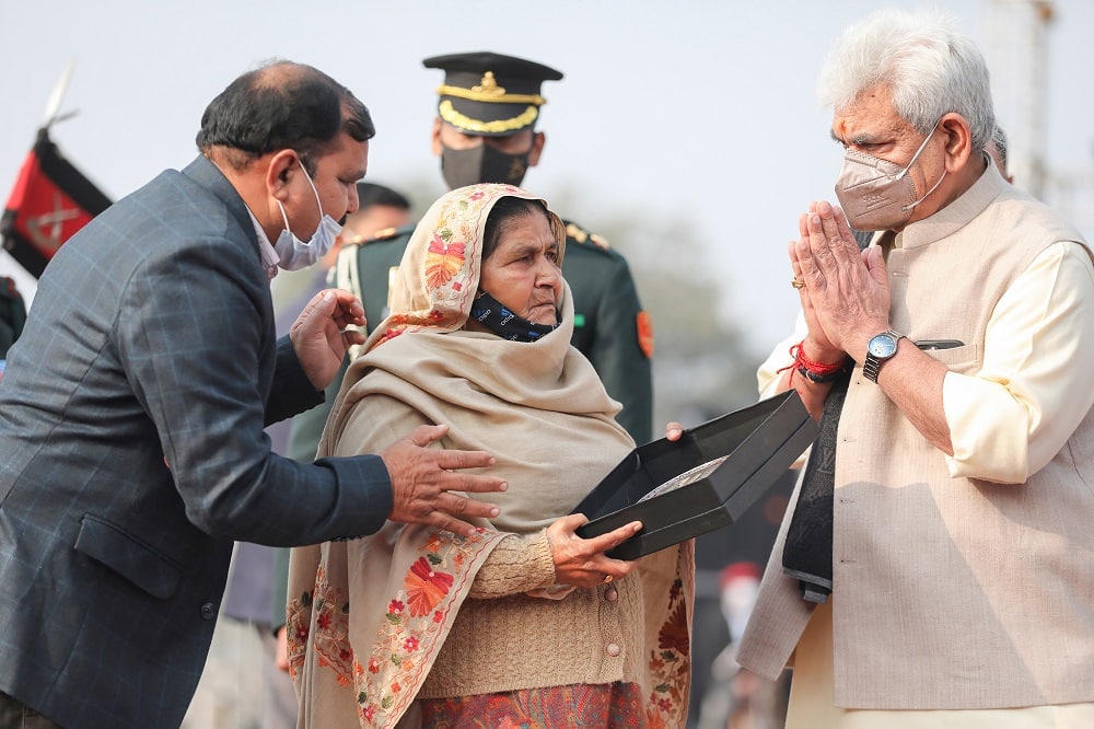 J&K Lt Governor Manoj Sinha honours kin of a martyr during Swarnim Vijay Varsh.