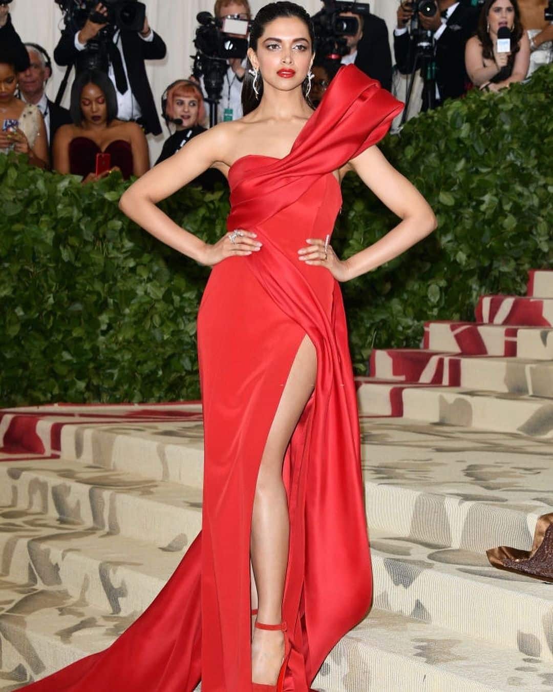 Deepika looks sensuous in a red thigh-high slit gown