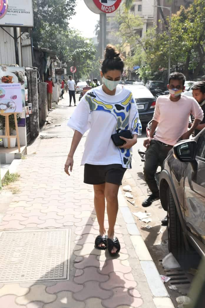 Shibani ties her hair in a top bun