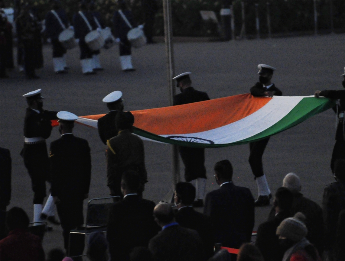 Navy personnel hold tricolour during the full dress rehearsal for the Beating Retreat ceremony. 