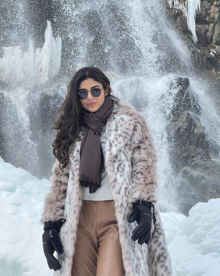 Mouni stands against waterfalls