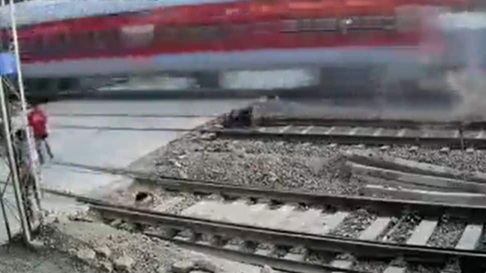 WATCH: Biker has a narrow escape from speeding Rajdhani Express in Mumbai, video goes viral