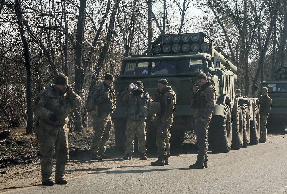Ukrainian soldiers stand with launch missile systems in Kharkiv 