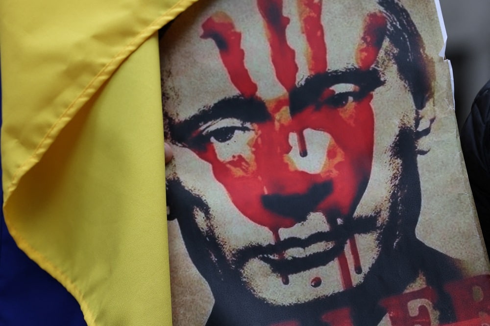 Blood-stained poster of Vladimir Putin showcased during protest at New York City