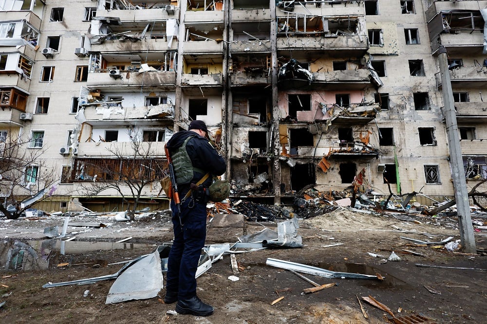 Ukrainian police official inspect a ravaged building after crash