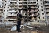 Ukrainian police official inspect a ravaged building after crash