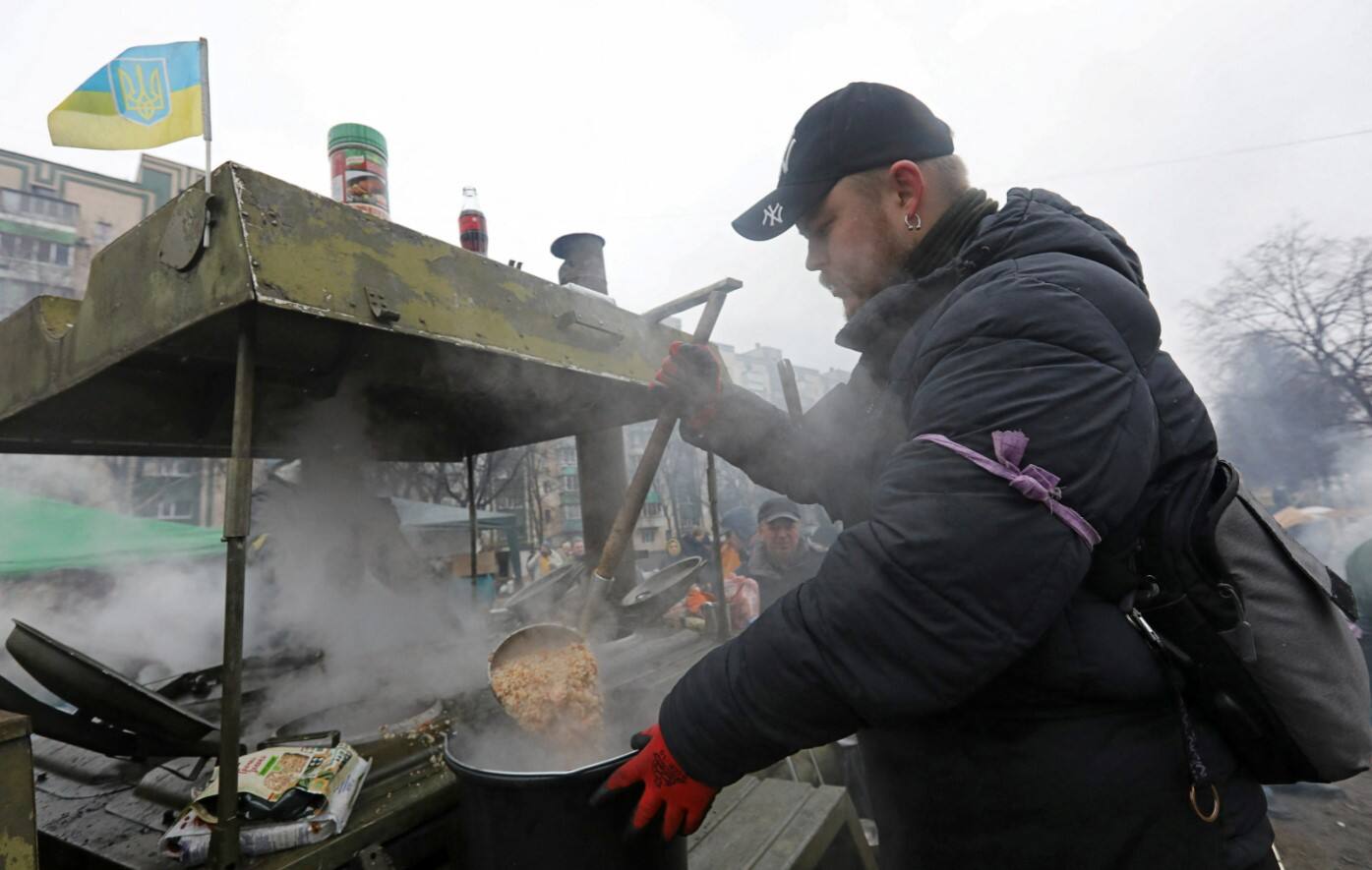 Man prepares food for local residents