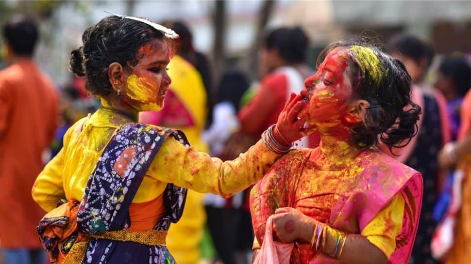 With colours, flowers and prayers; India rings in Holi - WATCH