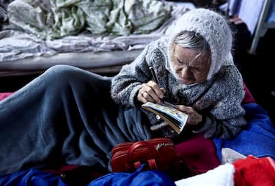 Elderly woman, who escaped Russian bombarding, now stays as a refugee in Lviv