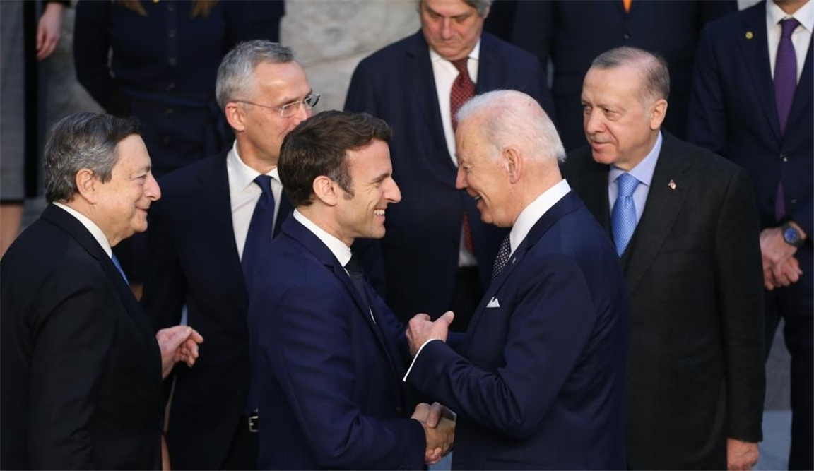French President Emmanuel Macron shakes hands with US President Joe Biden