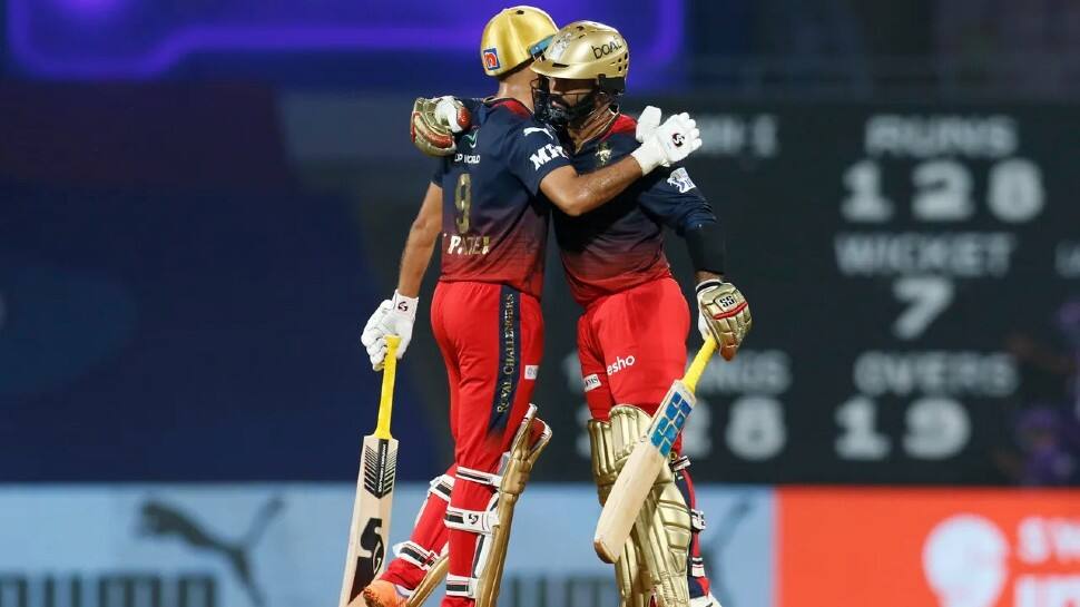 RCB batter Dinesh Karthik hugs teammate Harshal Patel after the win over KKR in their IPL 2022 match. Karthik became the second wicketkeeper to play 200 IPL matches as a wicketkeeper. MS Dhoni is on top, featuring in 215 games. (Source: Twitter)