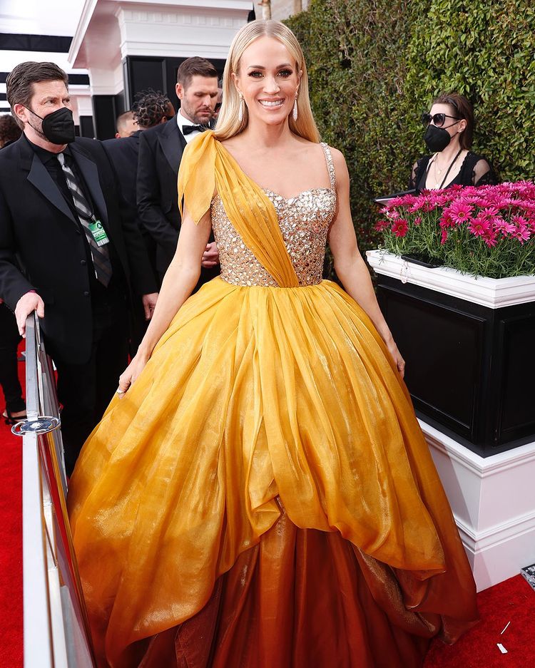 Carrie Underwood looks like a Disney Princess in a gold ombré Dolce and Gabbana ballgown