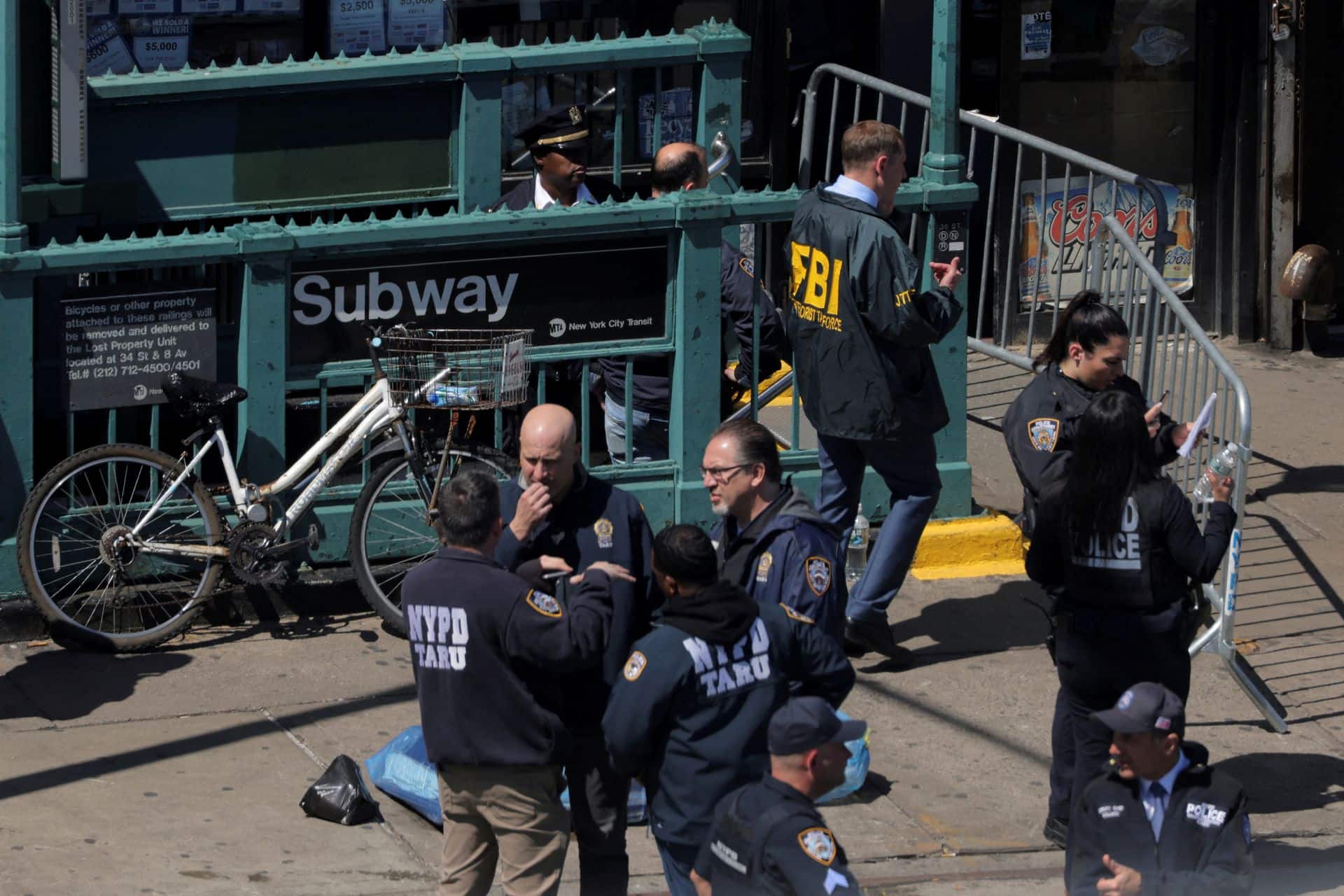 Officials stand outside the subway station