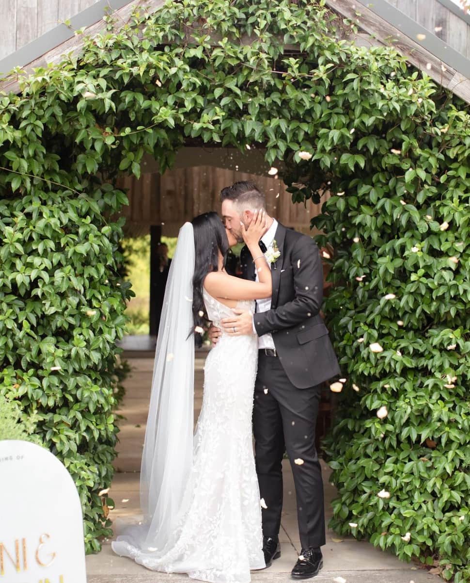 RCB all-rounder Glenn Maxwell kisses his wife Vini Raman after their wedding. Maxwell had got engaged to Vini in March 2020 but the wedding got delayed due to COVID-19 pandemic. (Source: Instagram)