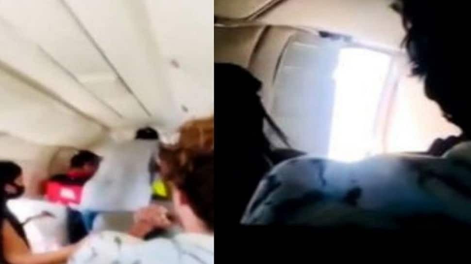 WATCH: Shocking video shows passengers desperately holding plane door as it opens mid-air