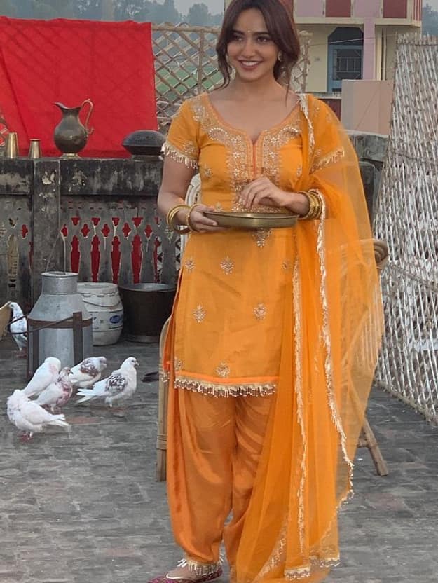 Neha looks beautiful in an orange traditional outfit