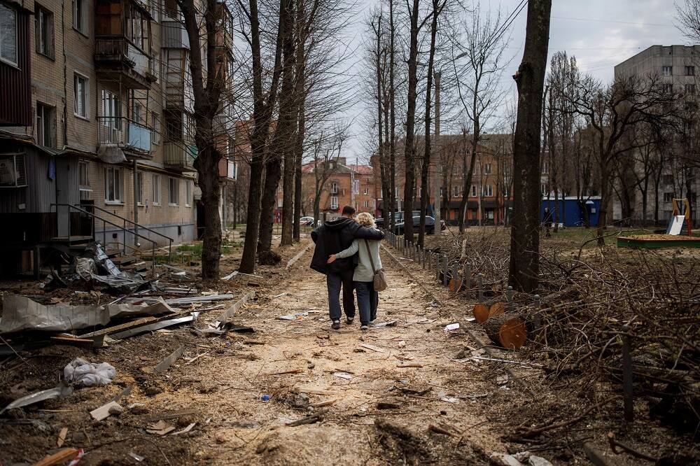 A couple walking across the ravaged streets of Ukraine amid war with Russia