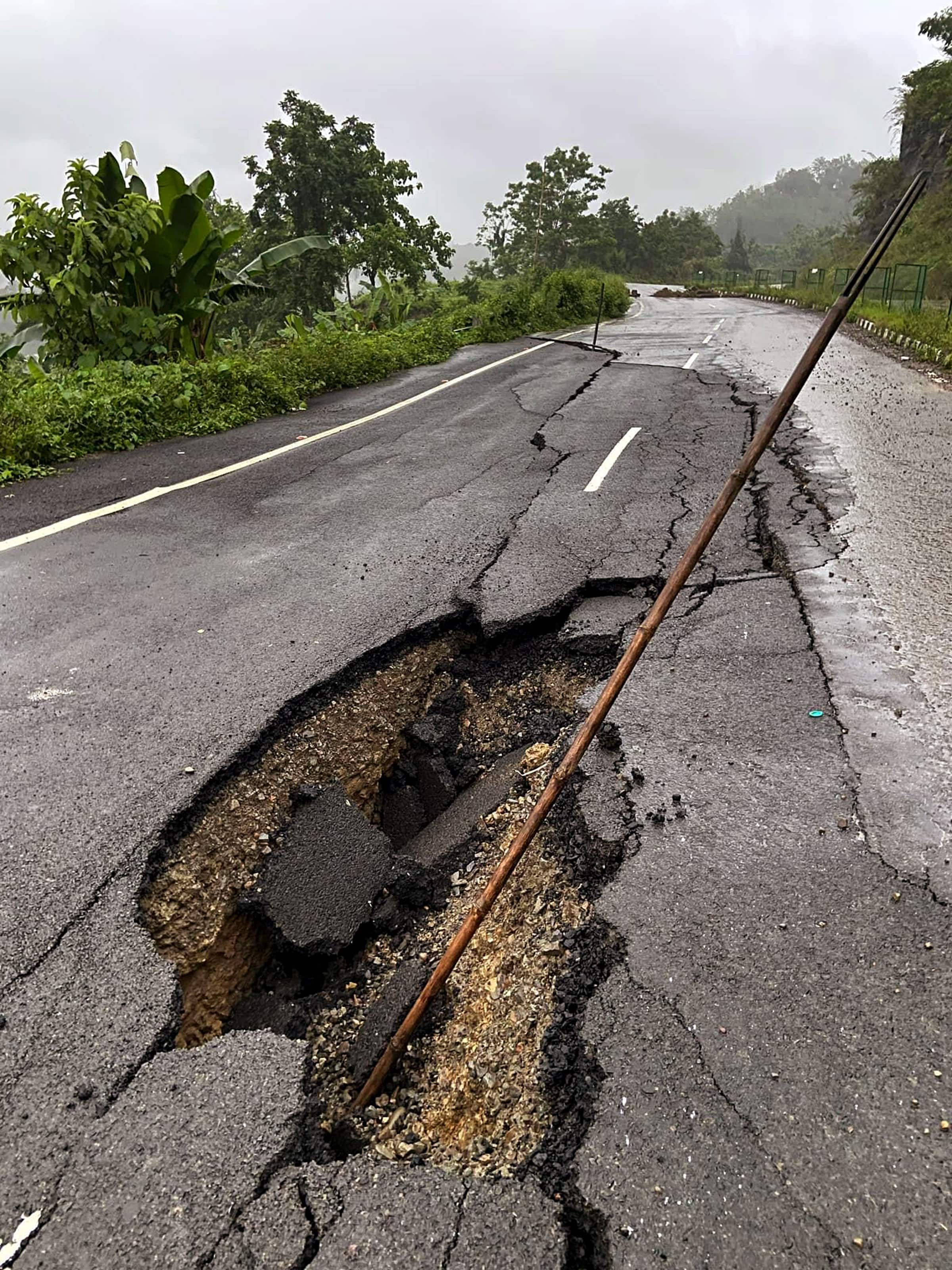 Heavy rains damage a road