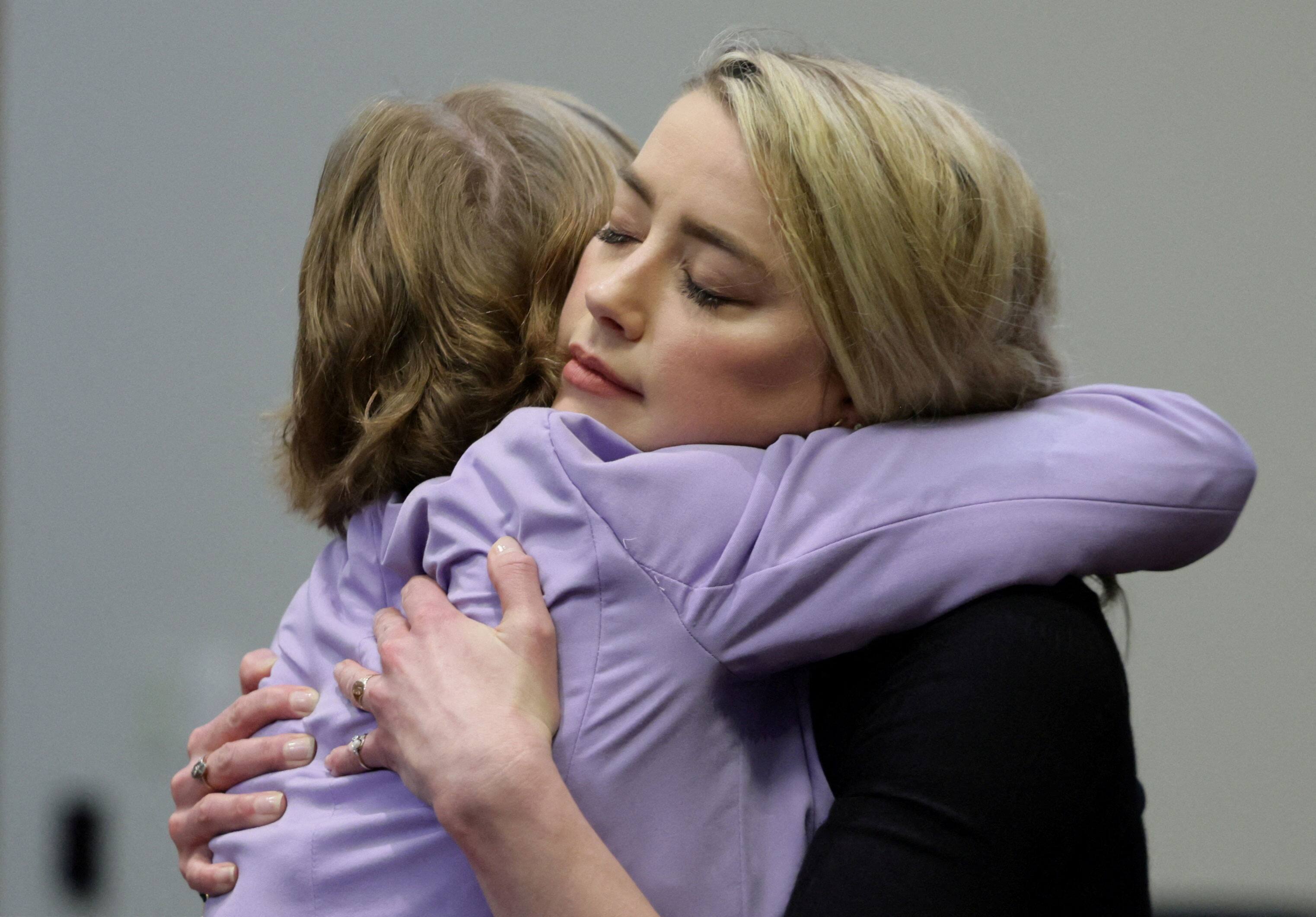 Amber Heard hugs her lawyer after verdict