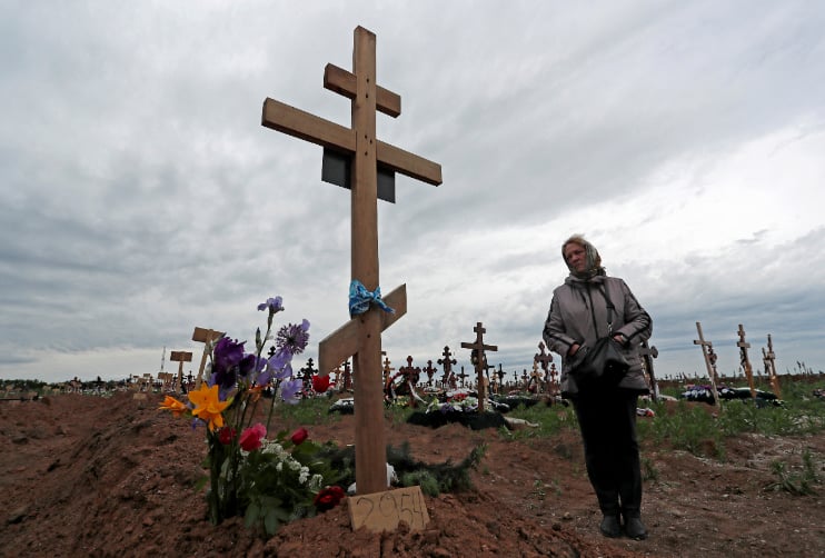 A woman visits her son's grave