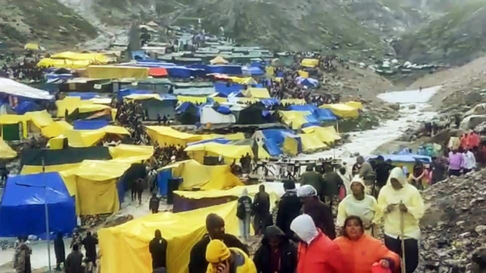 Assisting pilgrims coming from cave shrine