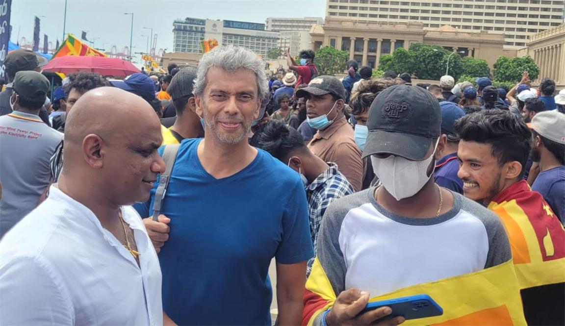 Former Sri Lanka cricket captain Sanath Jayasuriya with protesters