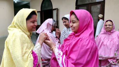 Women greet each other on the occasion of Eid-al-Adha