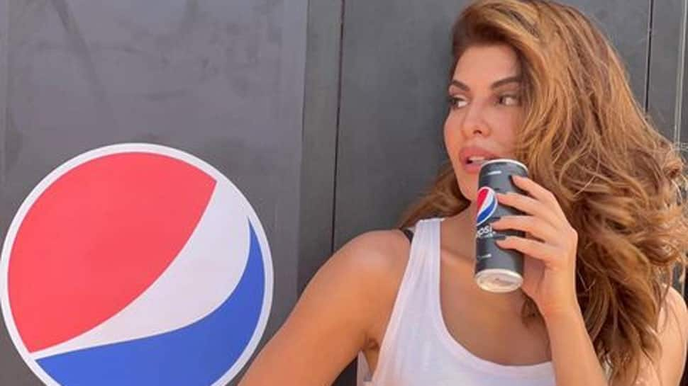 Jacqueline Fernandez oozes oomph in ripped denim shorts with Pepsi in hand - See photos from her latest ad