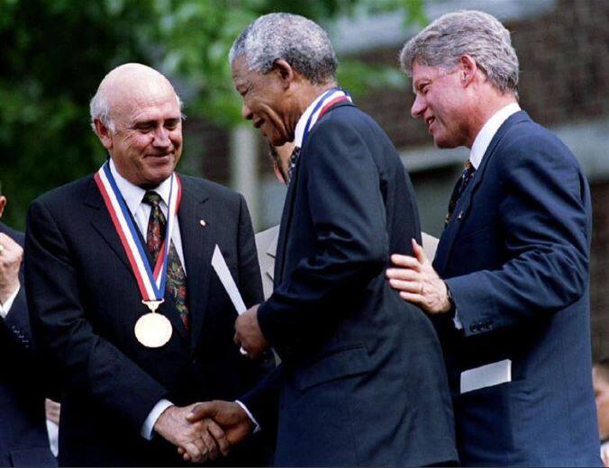 Then South African President F. W. DeKlerk shakes hands with Nelson Mandela