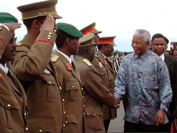 Nelson Mandela shakes hands with high ranking military officers