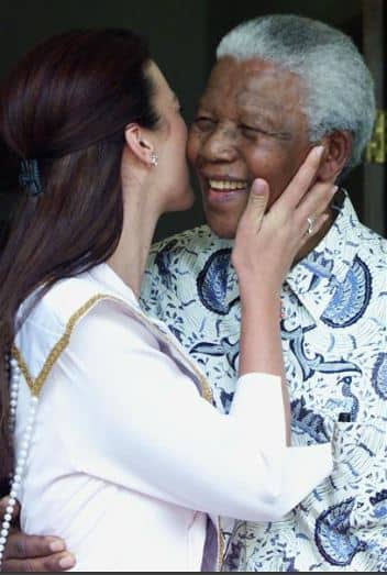 Nelson Mandela receives a kiss from then Miss South Africa, Cindy Nel