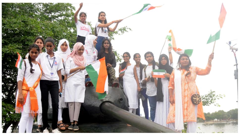 Students hold tricolors stand on a Pakistan Patton tank in Hyderabad