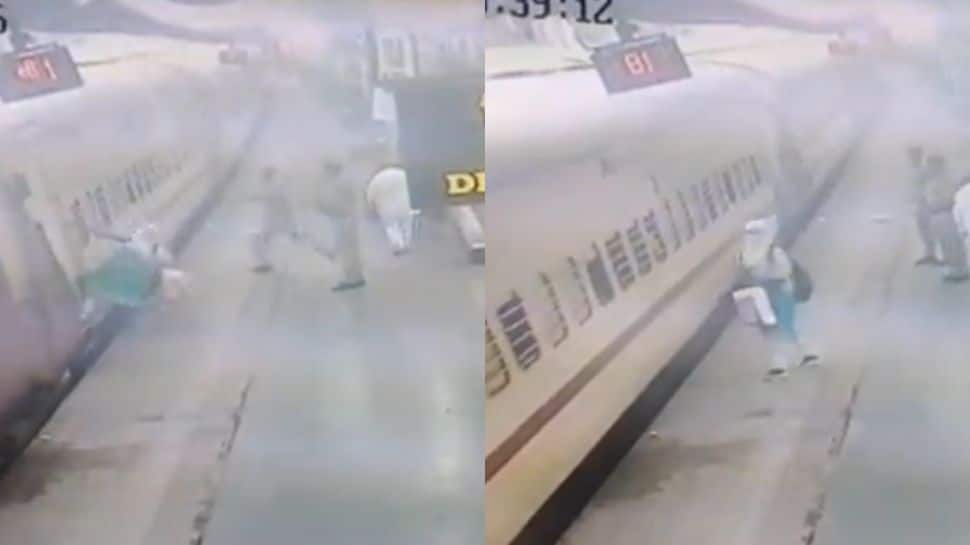 Young woman SLIPS while trying to board a train at Solapur Railway Station, what happens next - WATCH