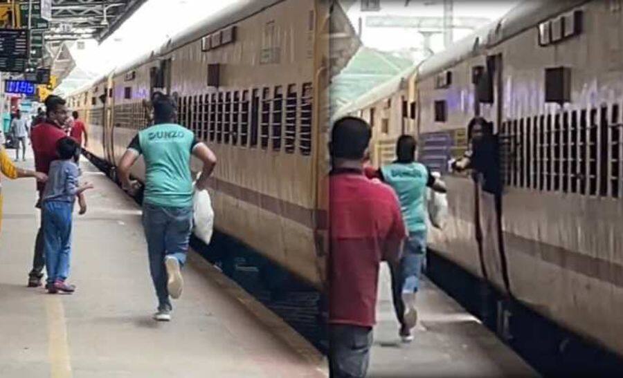 Dunzo delivery guy RAN along the moving train on the platform to DELIVER a parcel to passenger | Viral video