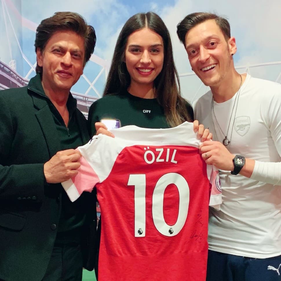 Former Arsenal midfielder Mesut Ozil with wife and model Amine Gulse and Bollywood superstar Shah Rukh Khan. Ozil was once accused of having a relationship with former Germany teammate Christian Lell's girlfriend, Melanie Rickinger, while the couple were still together. (Source: Twitter)