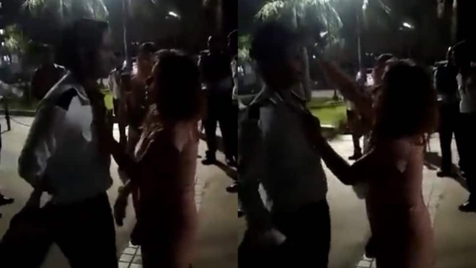 Noida: Drunk woman grabs society guard by collar, flings his cap in the air - WATCH