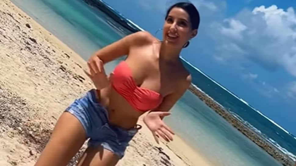 970px x 545px - Nora Fatehi oozes oomph in a HOT bandeau bikini top with tiny denim shorts  while dancing on the beach - Watch | People News | Zee News
