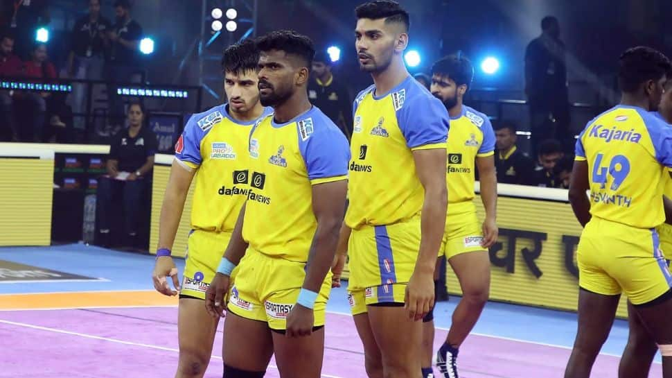 Tamil Thalaivas' K. Prapanjan, in blue and yellow jersey, is pinned down by  players of Patna Pirates during their Vivo Pro Kabaddi league match in  Mumbai, India, Saturday, Aug. 26, 2017. (AP