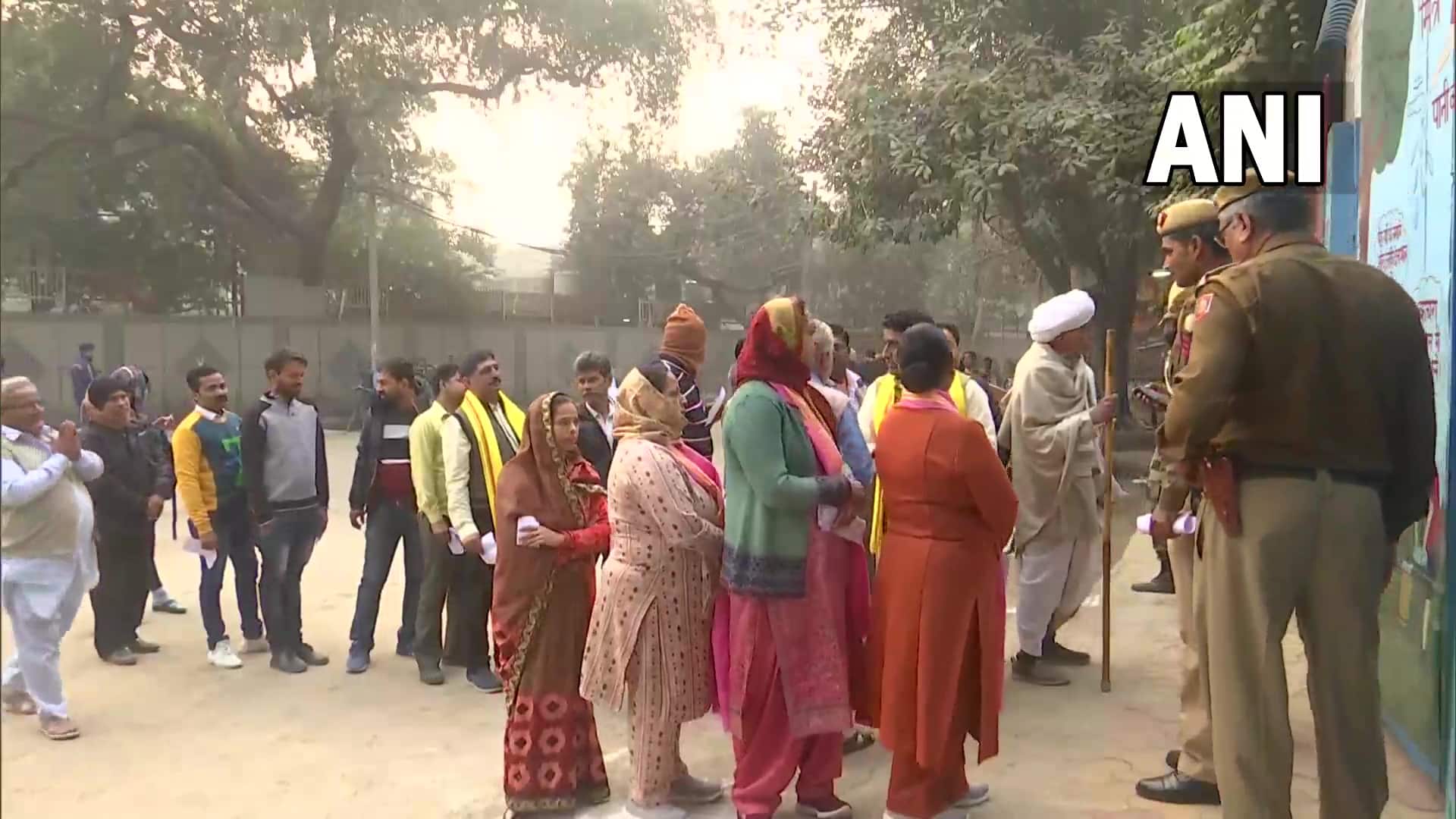 People queue up to cast their votes at a polling booth 