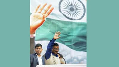 Delhi's CM Arvind Kejriwal waves at the crowd after winning MCD Polls