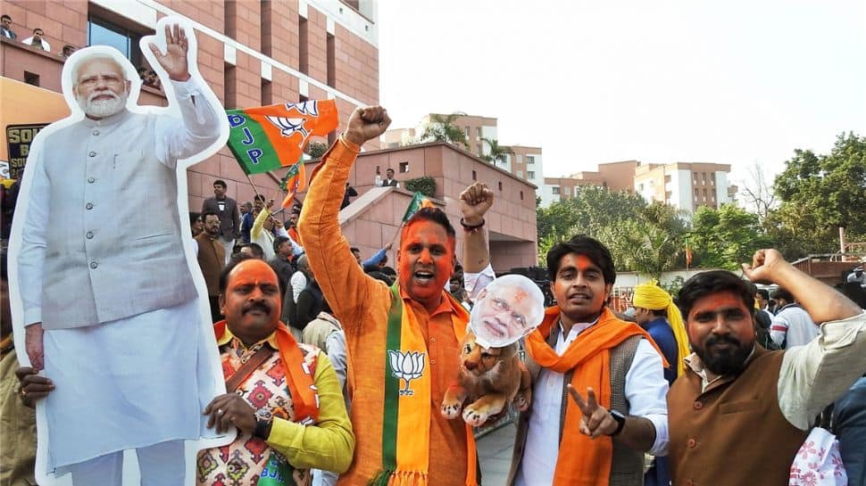 BJP workers holds PM cut-out, celebrates victory in Gujarat