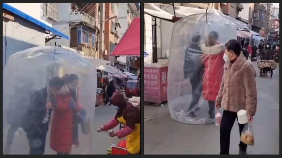 Covid bubble: Couple in China uses innovative &#039;shield&#039; in public against Covid- watch video viral