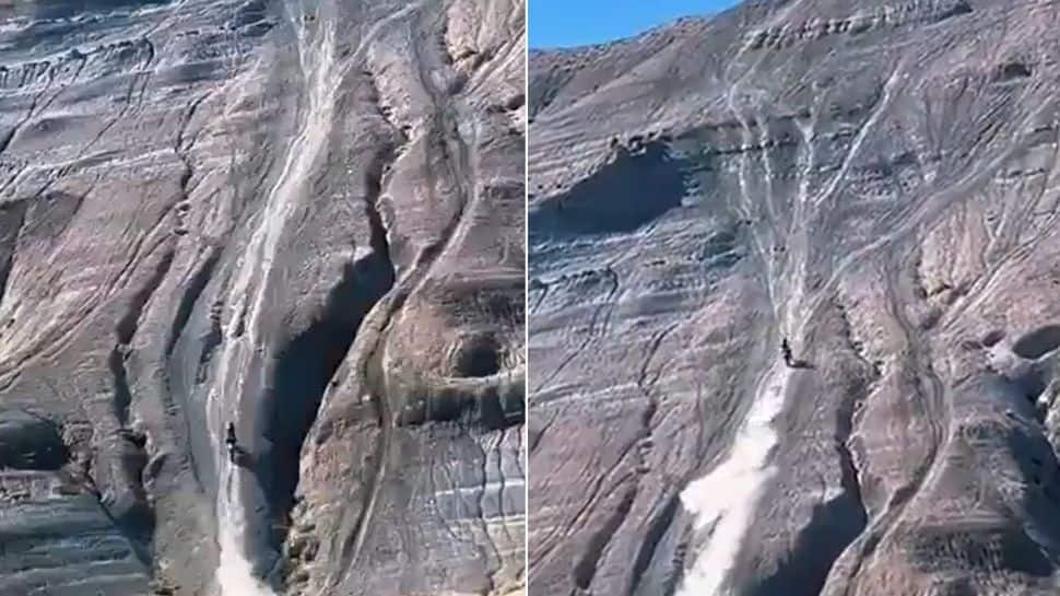 SCARY! Man rides bike on near vertical mountain, skids on the way up: Watch VIRAL video