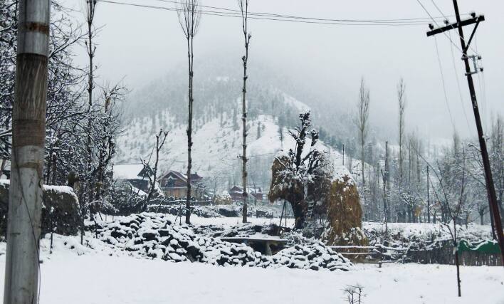 People enjoy fresh snowfall in Kashmir