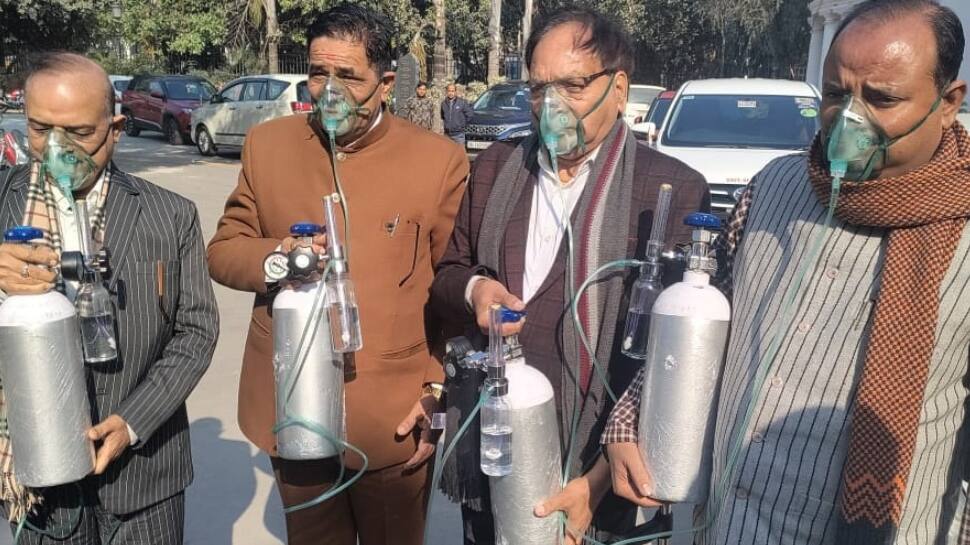 BJP MLAs enter Delhi assembly with oxygen cylinders, say ‘people are choking, but AAP govt sitting like a lame duck’