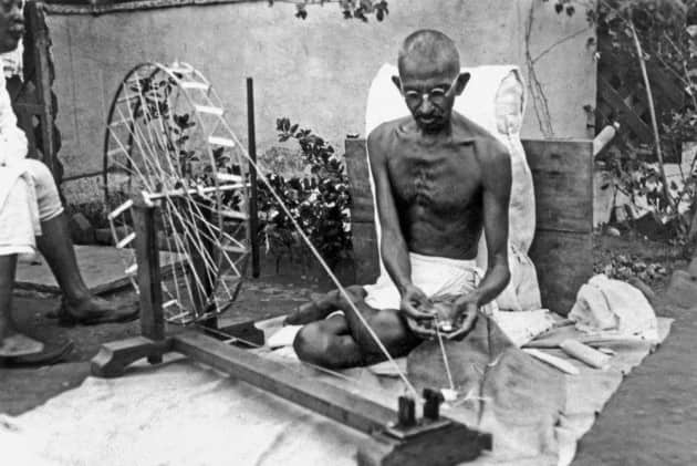 Gandhiji with his Charkha.