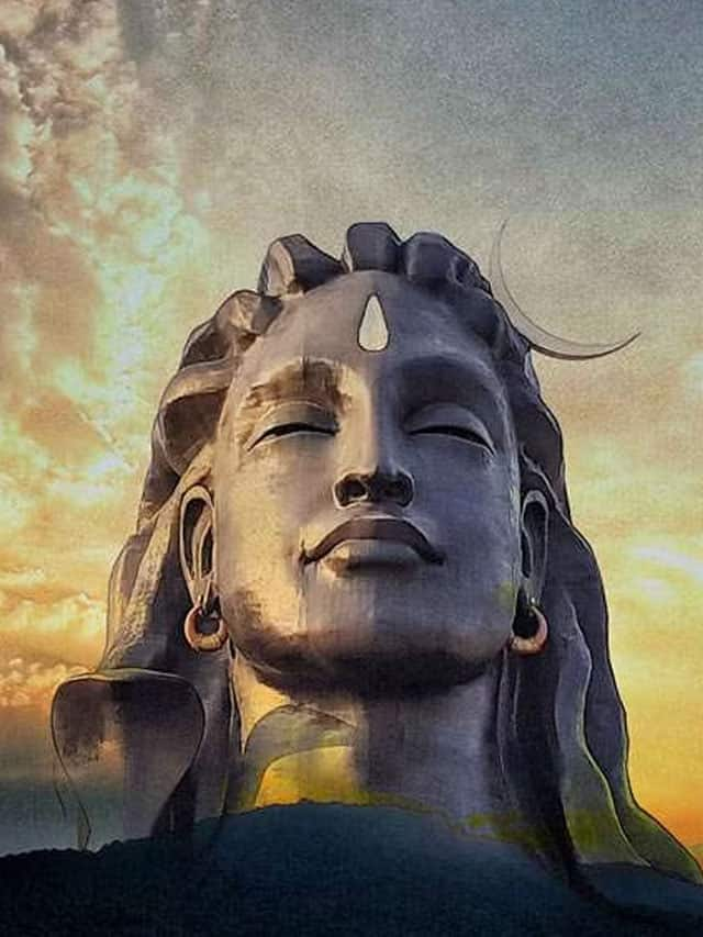 Devotee paying salutaion to the adiyogi shiva in yog asnam image is taken  at coimbatore india showing the god statue in mountain and sky background.  T Stock Photo - Alamy